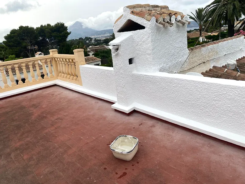 Roof terrace with freshly whitewashed walls and chimney