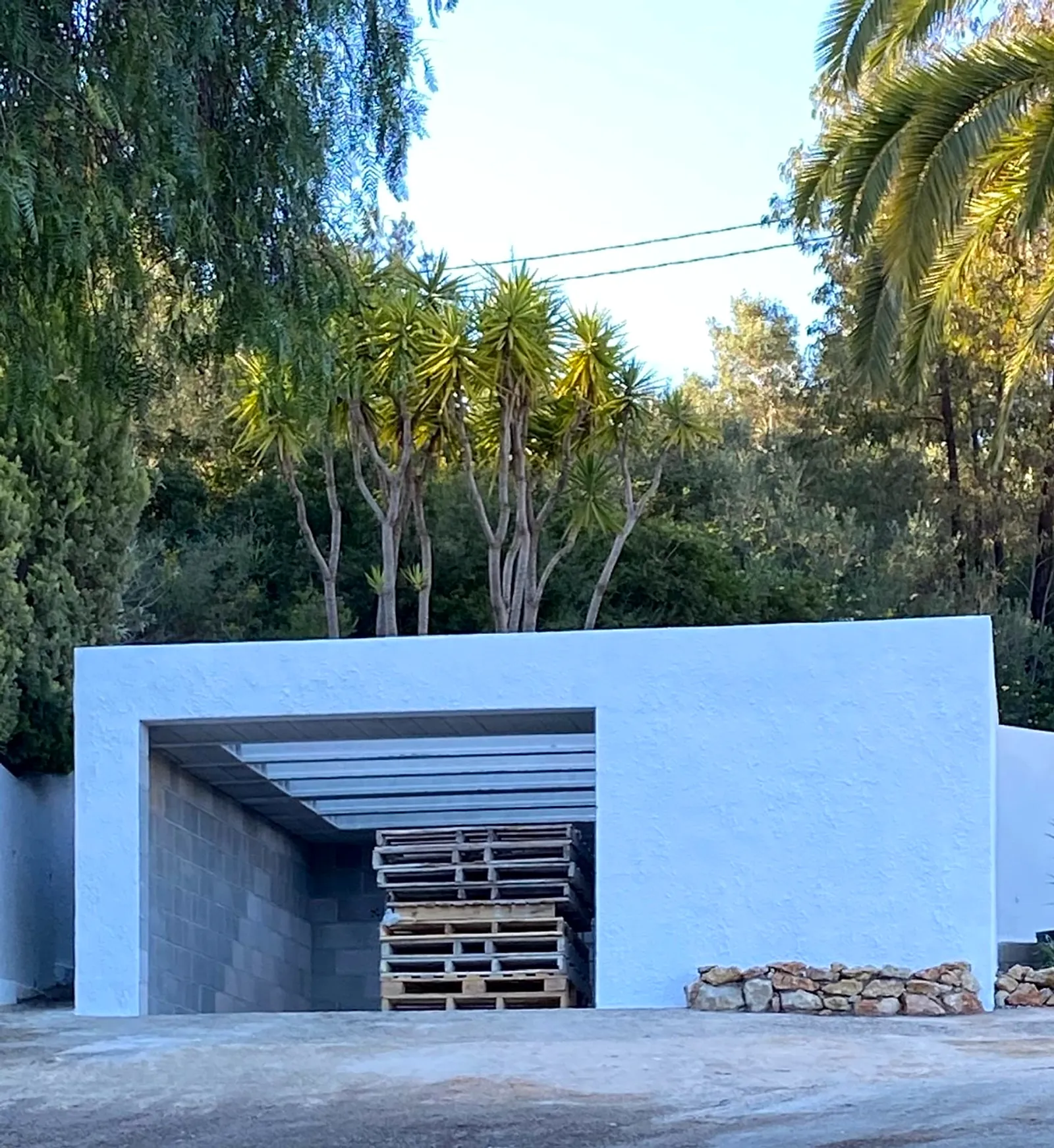 Stage 8: the finished garage extension among the palm trees