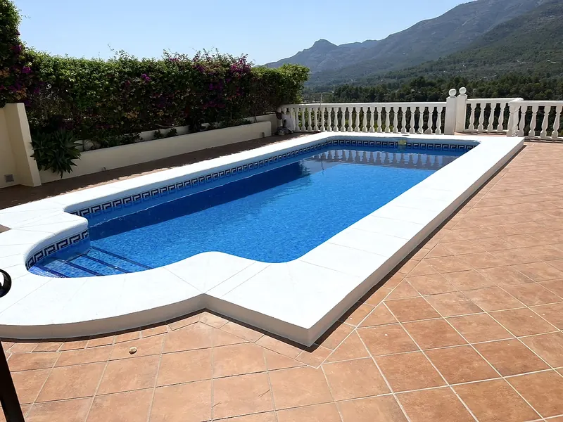 Restored pool with white coping, terracotta terrace and bougainvillea