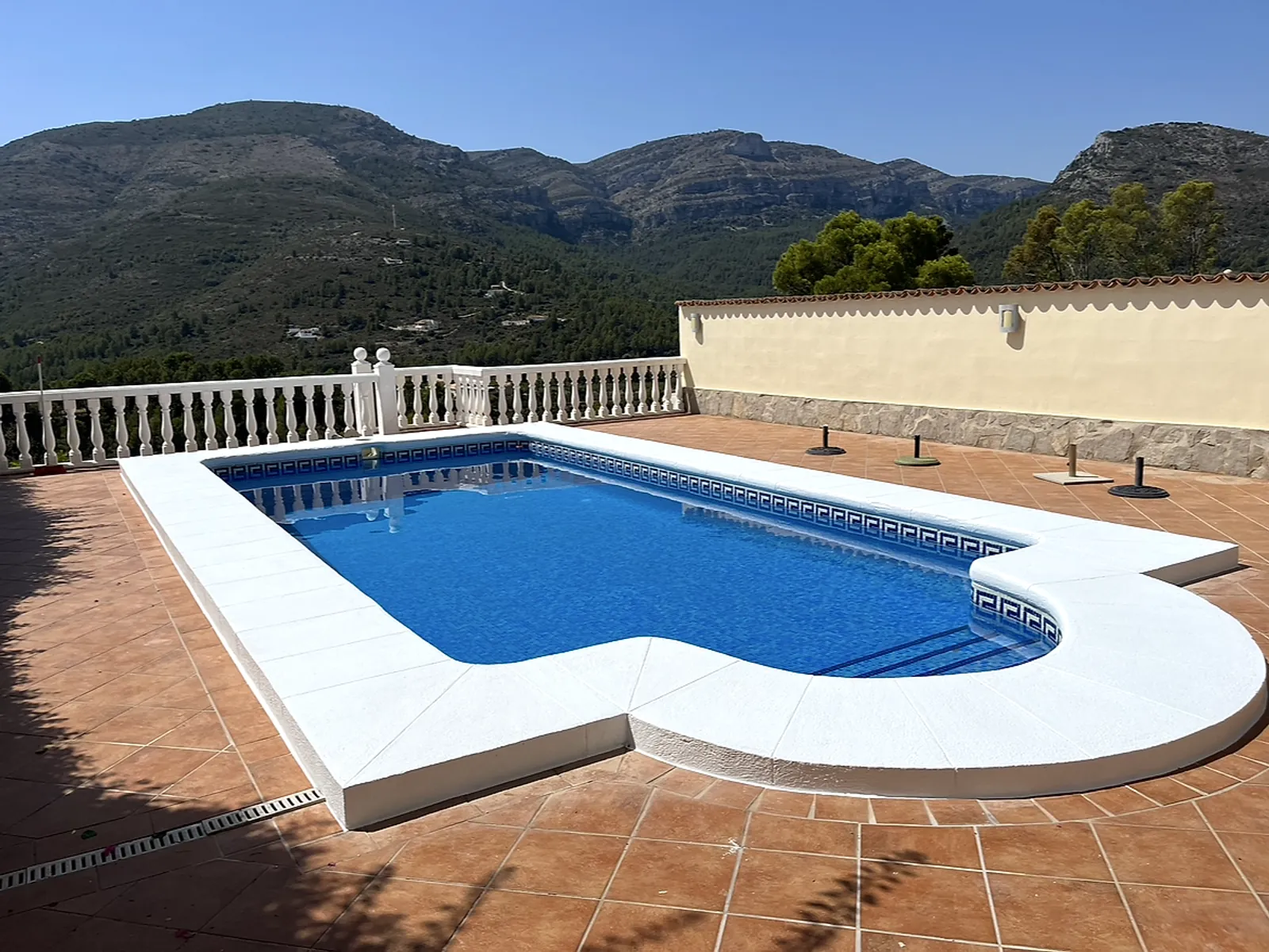 After: the same pool with bright white coping