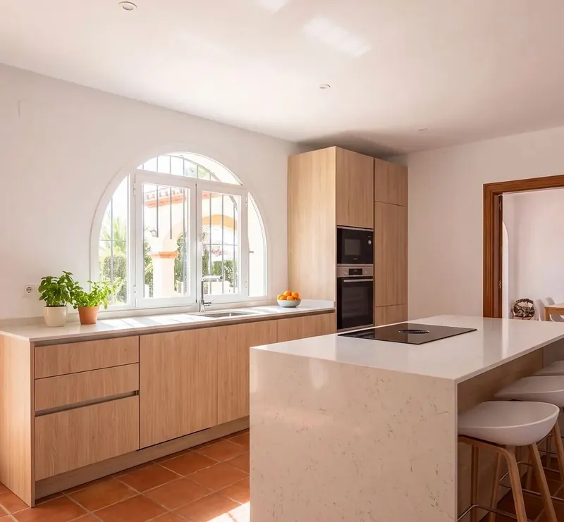 Modern kitchen with wood-effect units, stone island and terracotta floor